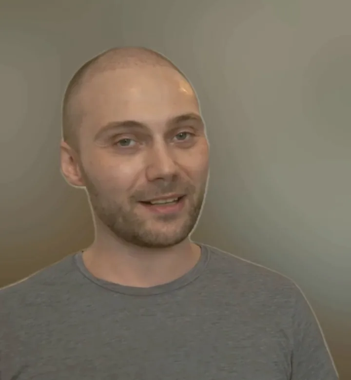 Michael in a grey t-shirt, talking to the camera in 2024